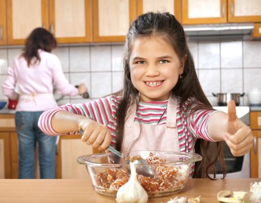 Anne ve kızı öğle yemeği için et hazırlamak