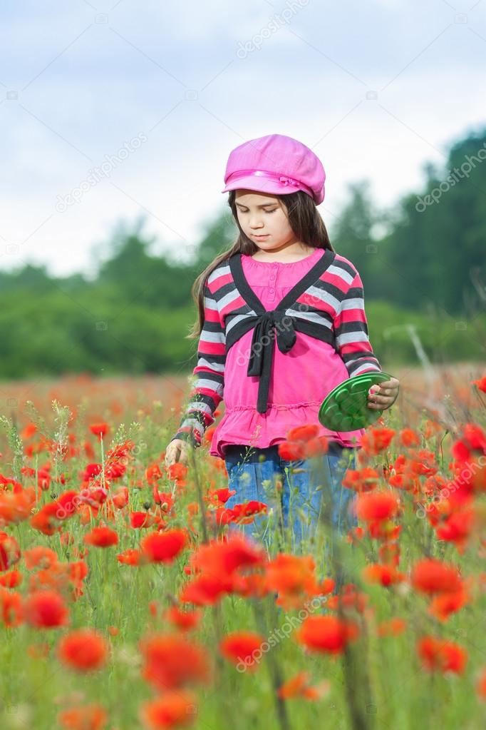 Vintage little girl on the poppy meadow