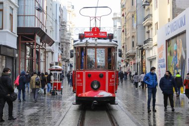 ISTANBUL, TURKEY - JANUARY 18, 2021: Historic Red Tram on Istiklal Avenue where is the most popular destination of Istanbul for shopping and entertainment.