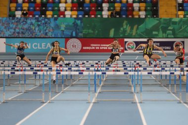 ISTANBUL, TURKEY - FEBRUARY 06, 2021: Athletes running 60 metres hurdles during Turkish Indoor Athletics Championships