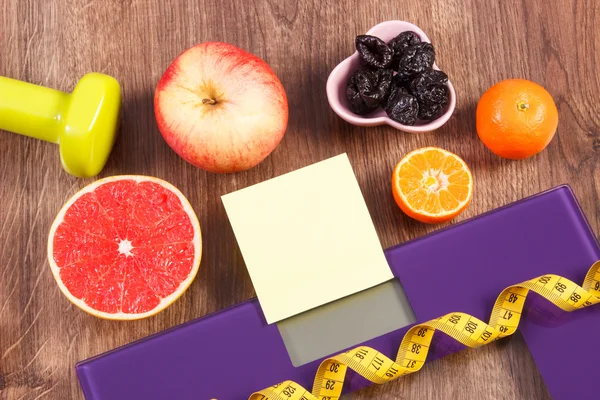 Electronic bathroom scale, centimeter, healthy food, dumbbells for fitness, slimming and healthy lifestyles concept