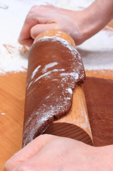 Hand with rolling pin kneading dough for gingerbread — Stock Photo, Image