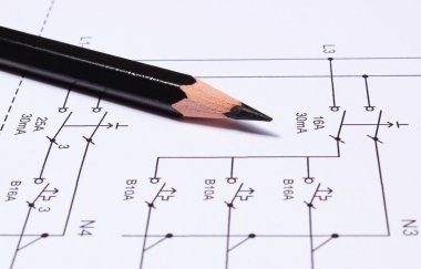 Pencil lying on electrical diagrams