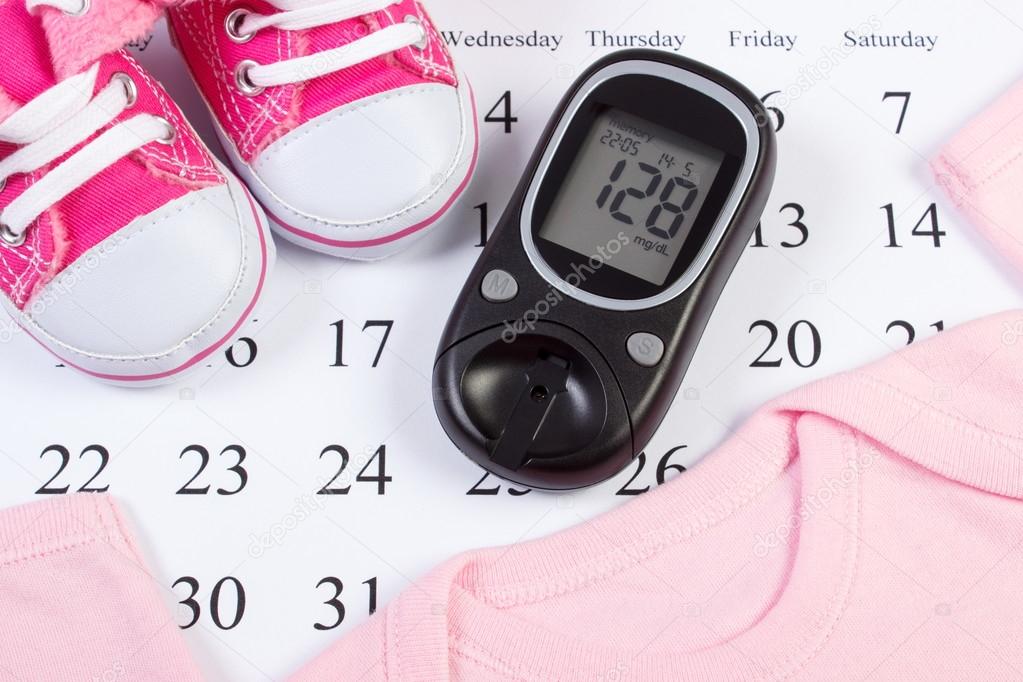 Glucometer and clothing for newborn, checking sugar level in pregnant, expecting for baby