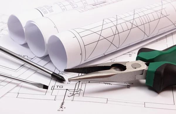 Rolls of diagrams and work tools on electrical construction drawing of house — Stock Photo, Image