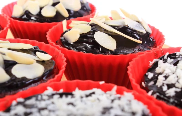 Chocolate muffins with desiccated coconut and sliced almonds — Stock Photo, Image