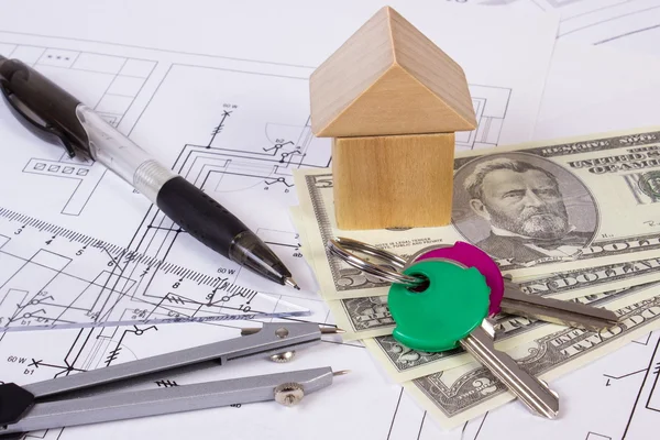 Casa de bloques de madera, monedas dólar y accesorios para el dibujo, concepto de casa de construcción — Foto de Stock
