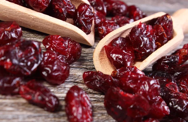 Heap of red cranberries with spoon on wooden table — Stock Photo, Image