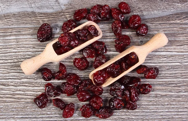 Heap of red cranberries with spoon on wooden table — Stock Photo, Image