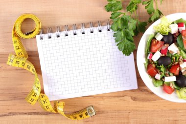 Taze Yunan salatası sebze, santimetre ve notlar, sağlıklı beslenme ve zayıflama kavramı yazmak için not defteri