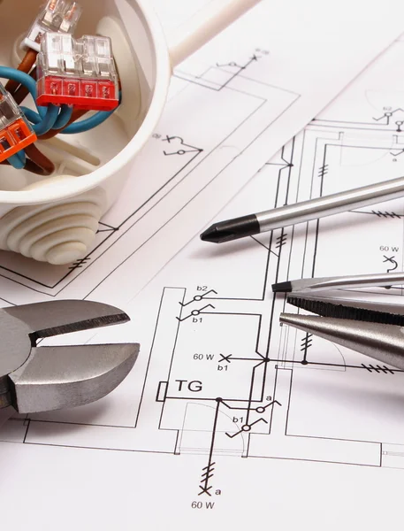 Work tools and electrical box with cables on construction drawing of house — Stock Photo, Image