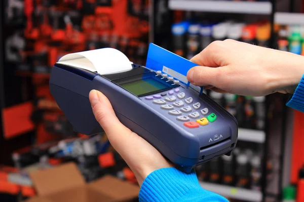 Paying with credit card in an electrical shop, finance concept