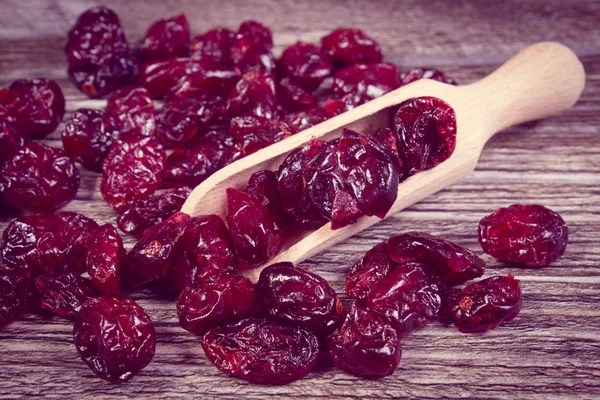 Vintage photo, Heap of red cranberries with spoon on wooden table — Stock Photo, Image