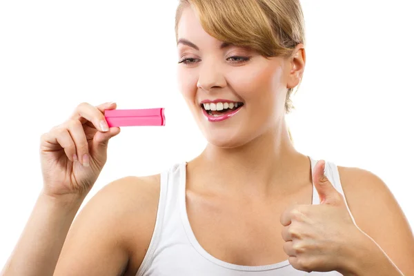 Šťastná žena při pohledu na těhotenský test s kladným výsledkem a ukazuje palec nahoru — Stock fotografie