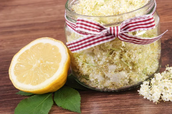 Holunderblüten und Zitrone zur Zubereitung von frischem gesunden Saft auf rustikalem Brett — Stockfoto