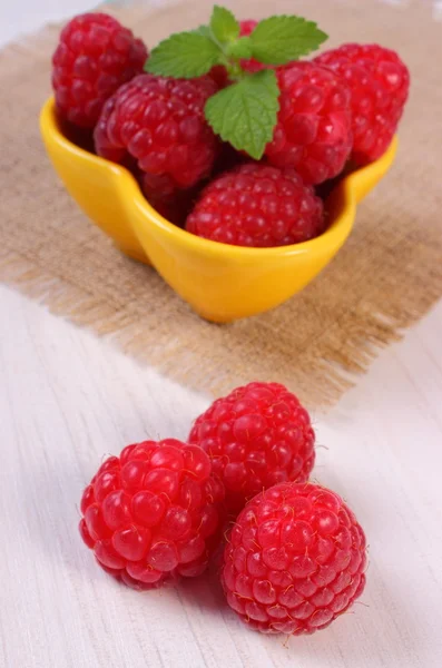 Fresh raspberries and lemon balm on white wooden table, healthy food — Stock Photo, Image