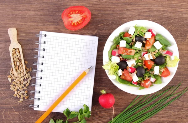 Salada grega fresca com legumes e bloco de notas para escrever notas, nutrição saudável — Fotografia de Stock