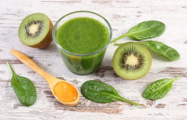 Ispanak ve eski ahşap zemin, sağlıklı beslenme üzerine bal ile kivi kokteyl