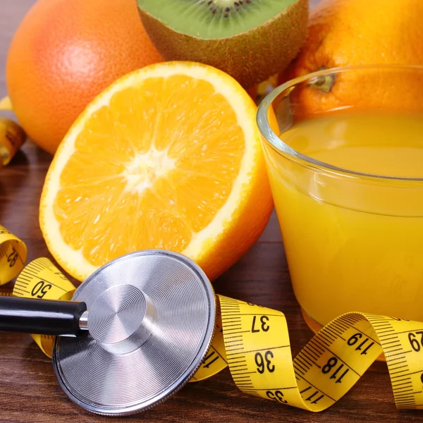 Stethoscope, fresh fruits, juice and centimeter, healthy lifestyles and nutrition