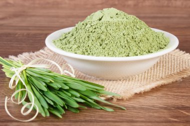 Barley grass and heap of young powder barley in bowl, body detox clipart
