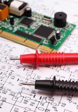 Baskılı devre kartı ve diyagram üzerinde multimetre elektronik kablo