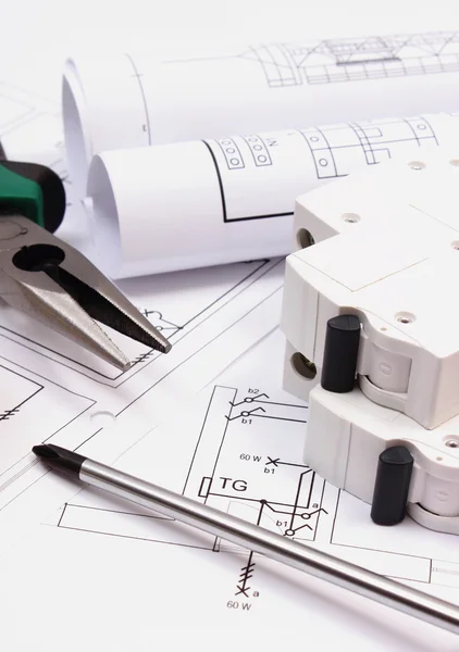 Strumenti di lavoro, fusibile elettrico e rotoli di diagrammi su disegno di costruzione di casa — Foto Stock
