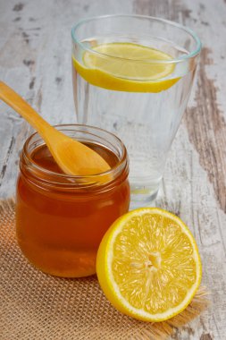 Taze limon bal ve su bir bardak dilim limon ile