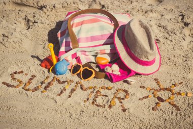 Yazın güneş şeklinde yazlık, dinlenmek ya da güneşlenmek için aksesuarlar ve kumsalda oynamak için çocuk oyuncakları. Seyahat, turizm ve tatil zamanı kavramı