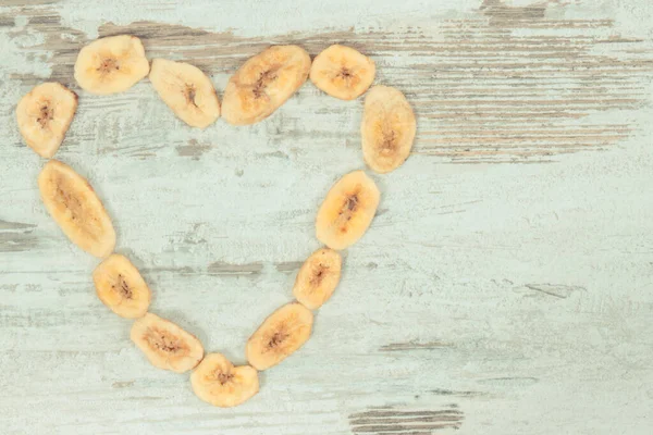 Heap Dried Organic Banana Chips Shape Heart Natural Snack Dessert — Stock Photo, Image