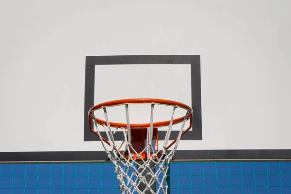 Basketball board with hoop on sky background. Sport and recreation time