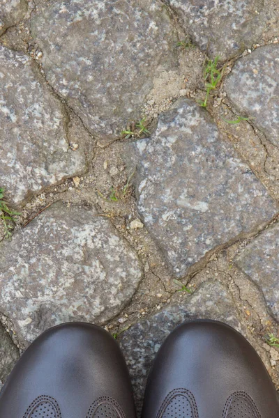 供道路上或人行道上的男人穿的舒适的浅褐色皮鞋 由石头或石头制成 案文或登记的位置 — 图库照片