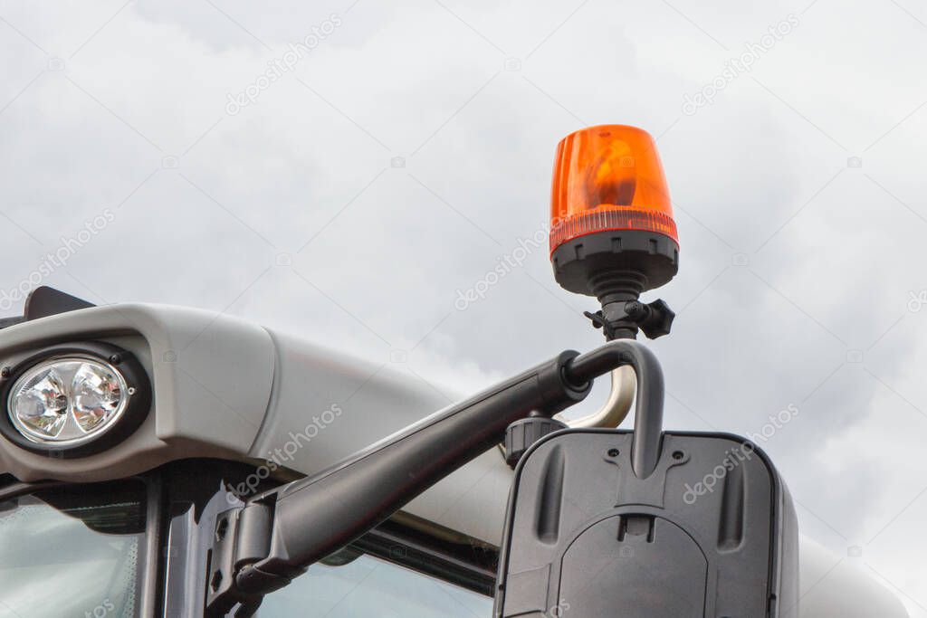 Orange signal lamp on forklift, excavator or other industrial and agricultural machine. Safety during work