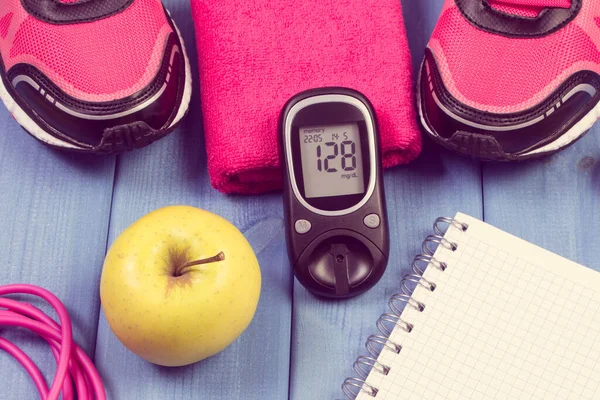 Glucometer for checking sugar level, pair of sport shoes and accessories for fitness. Diabetes and healthy sporty lifestyles