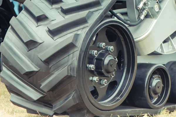 Detail and part of metal wheel with caterpillar. Transportation and technology concept