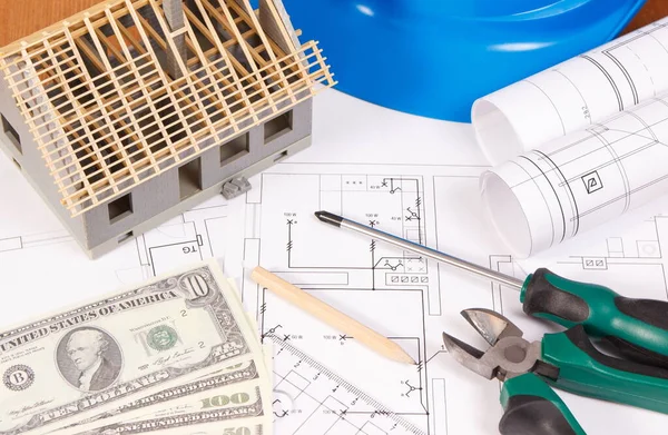 Electrical construction drawings or diagrams, work tools and accessories for engineer jobs, small house and currencies dollar, building home cost concept