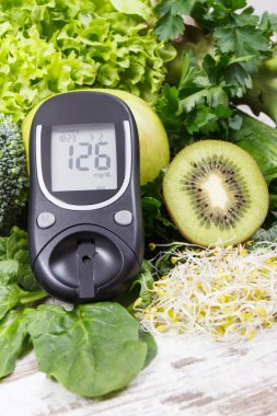 Şeker seviyesi ve sebzeleri ölçmek için kullanılan glukometre, vitamin ve mineral içeren diyabet sırasında sağlıklı besin olarak filizlenir.