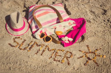 Yazın, kehribar taşı ve aksesuarlardan oluşan güneş şeklinde bir yazı. Rahatlamak için ya da kumsalda güneşlenmek için. Seyahat ve tatil zamanı kavramı