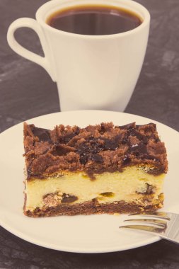 Beyaz tabakta fırında peynirli kek ve sade kahve. Farklı durumlar için lezzetli bir tatlı.