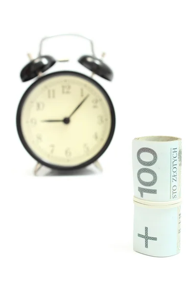 Roll of tied banknotes with retro styled alarm clock — Stock Photo, Image