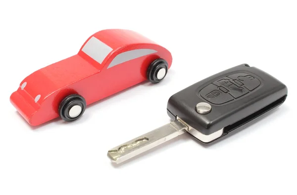 Old red toy car and vehicle key on white background — Stock Photo, Image