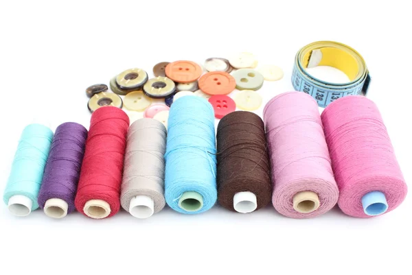 Colorful spools of thread, tape measure and buttons — Stock Photo, Image