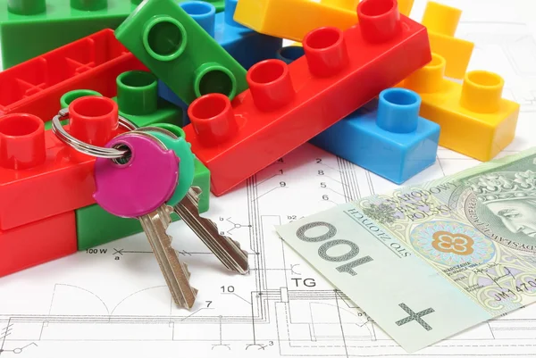 Home keys, colorful building blocks and money on housing plan — Stock Photo, Image