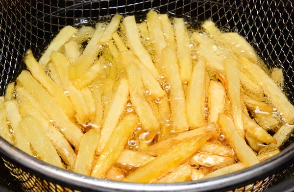 French fries fried in oil — Stock Photo, Image