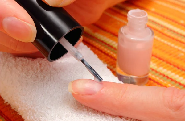 Nail polish applied to the hand of woman — Stock Photo, Image