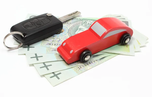Money, wooden red toy car and key vehicle. White background — Stock Photo, Image
