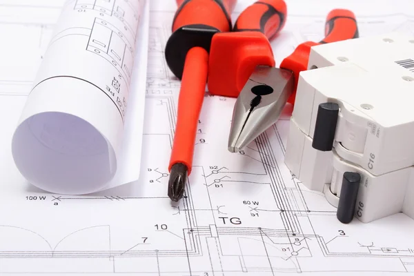 Rolled electrical diagrams, electric fuse and work tools on construction drawing of house — Stock Photo, Image