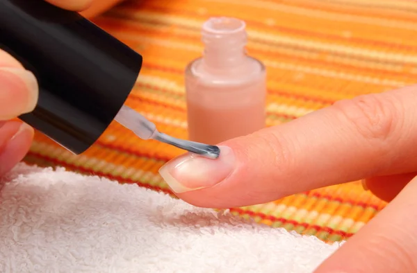 Nail polish applied to the hand of woman — Stock Photo, Image