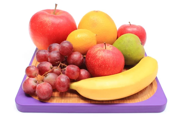 Fresh natural fruits on cutting board — Stock Photo, Image