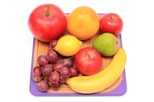 Fresh natural fruits on cutting board — Stock Photo, Image
