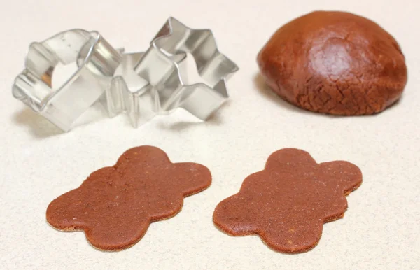 Gingerbread dough for Christmas cookies and cookie cutters — Stock Photo, Image